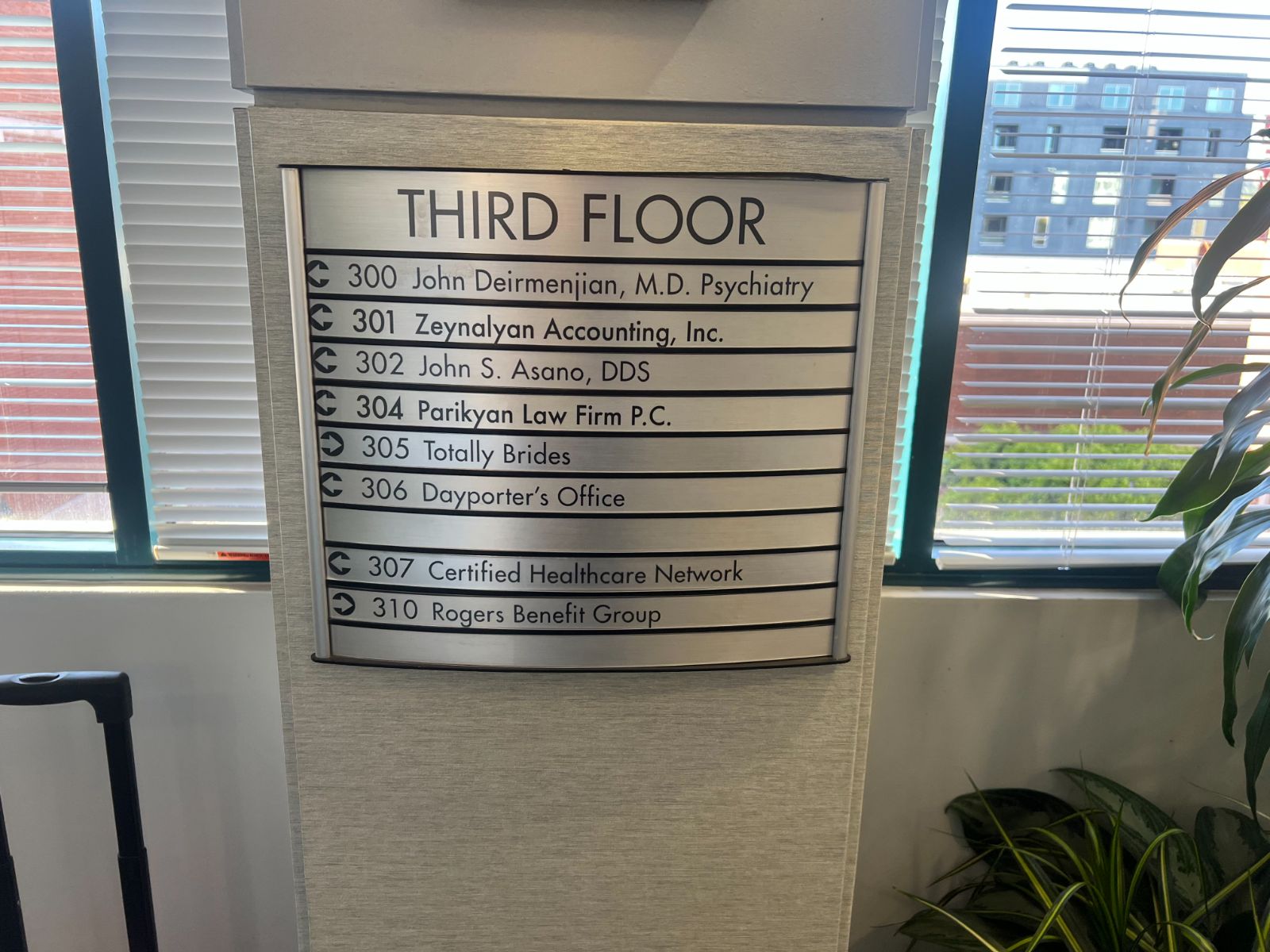 Brushed-aluminum tenant directory listing suite numbers and business names