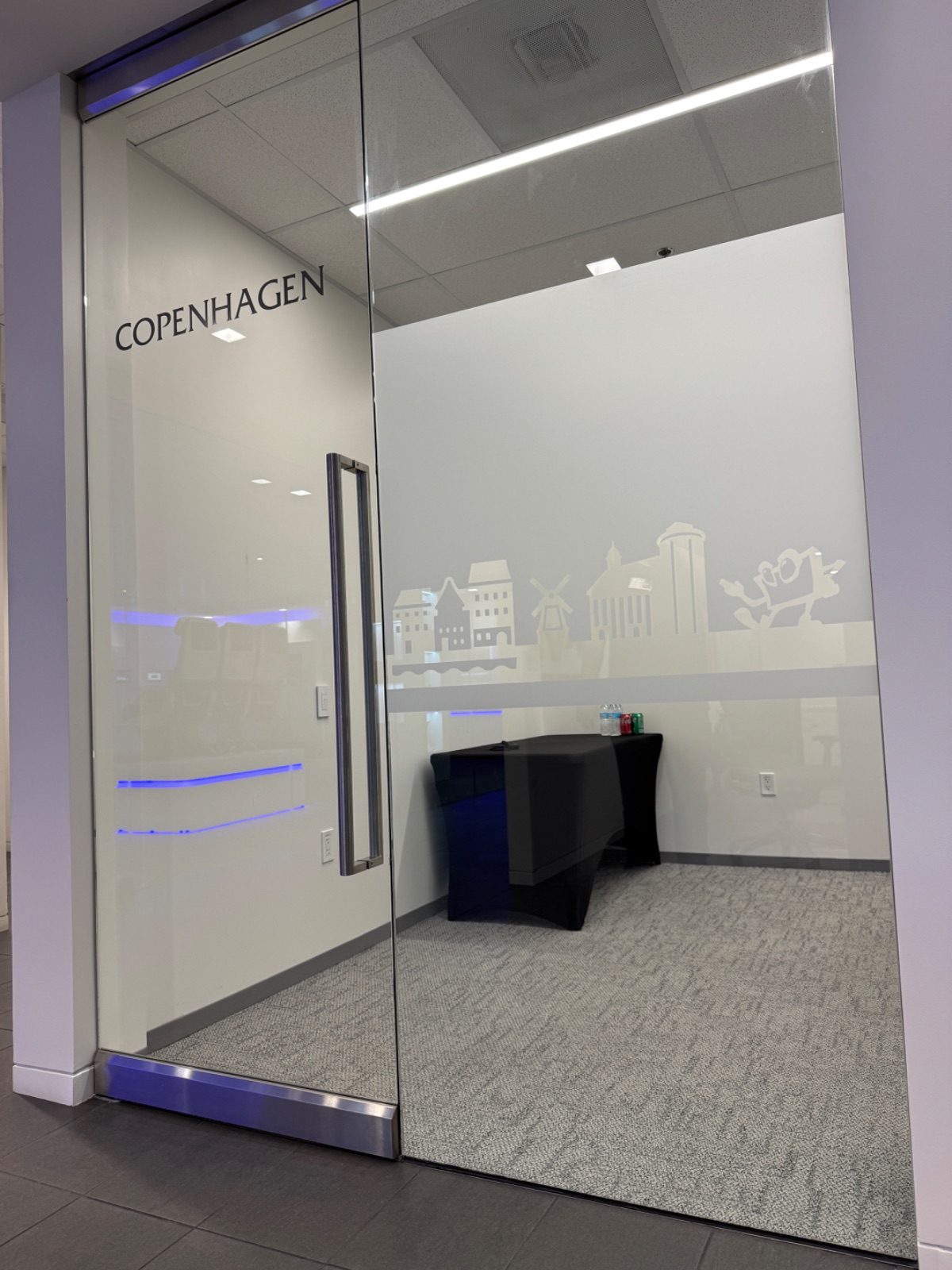 Frosted glass office room front with a cut-vinyl Copenhagen skyline and the room name COPENHAGEN