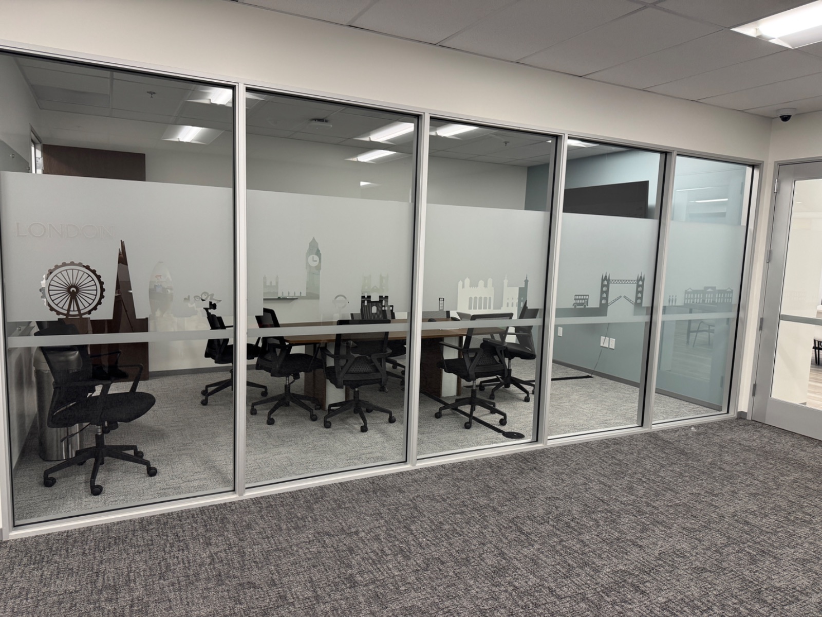 Interior view of the London meeting room glass, cut-vinyl landmarks reading correctly from inside the room